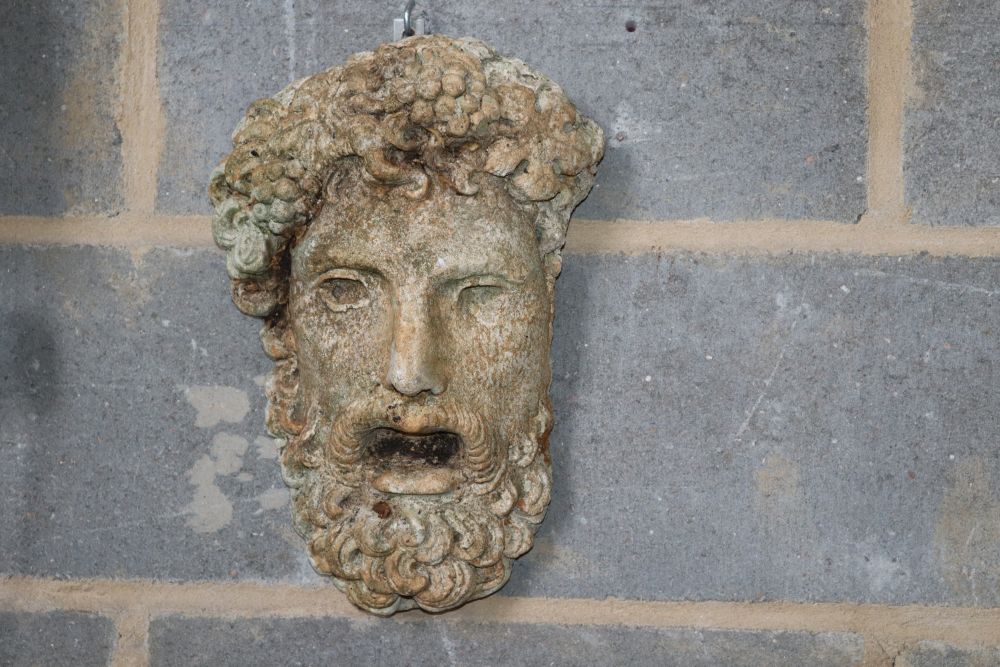 A stone bacchus garden wall mask and a cupped hands bird bath, wall plaque W.23cm, H.33cm,